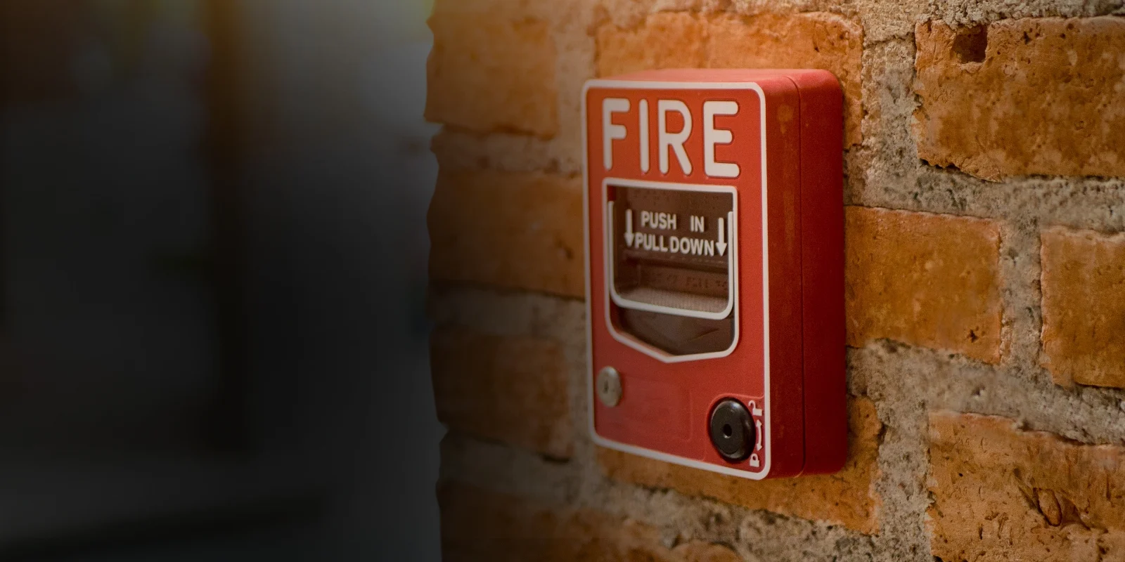 Pulsante manuale di allarme incendio installato su una parete